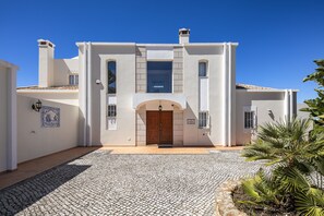 A two-story building with a central entrance, a tiled courtyard, and a sign indicating 'Casa Fleitas.'