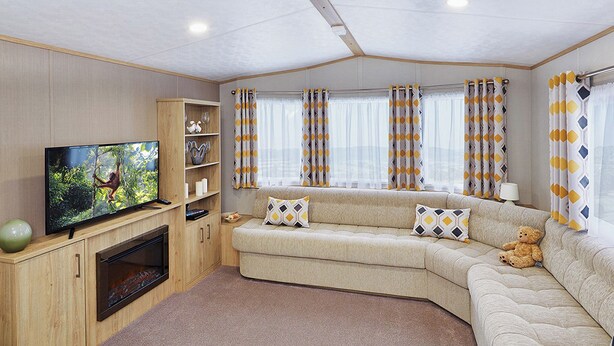 A cozy living room with a sofa, a television, a fireplace, and curtains. - A modern holiday home with one master double and two twin bedrooms. (Cresswell beach)