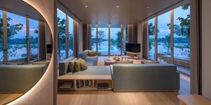 A modern living room with large windows, a sofa set, a TV, and a small table. - sala bang pa-in, a Member of Design Hotels (Bang Pa-in)