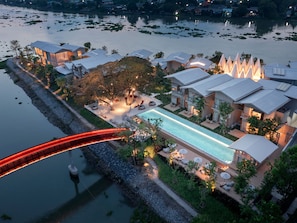 A resort with a swimming pool, outdoor seating, and a bridge. - sala bang pa-in, a Member of Design Hotels (Bang Pa-in)