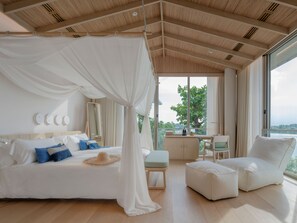 A bedroom with a canopy bed, a desk, and a view of the outdoors. - sala bang pa-in, a Member of Design Hotels (Bang Pa-in)
