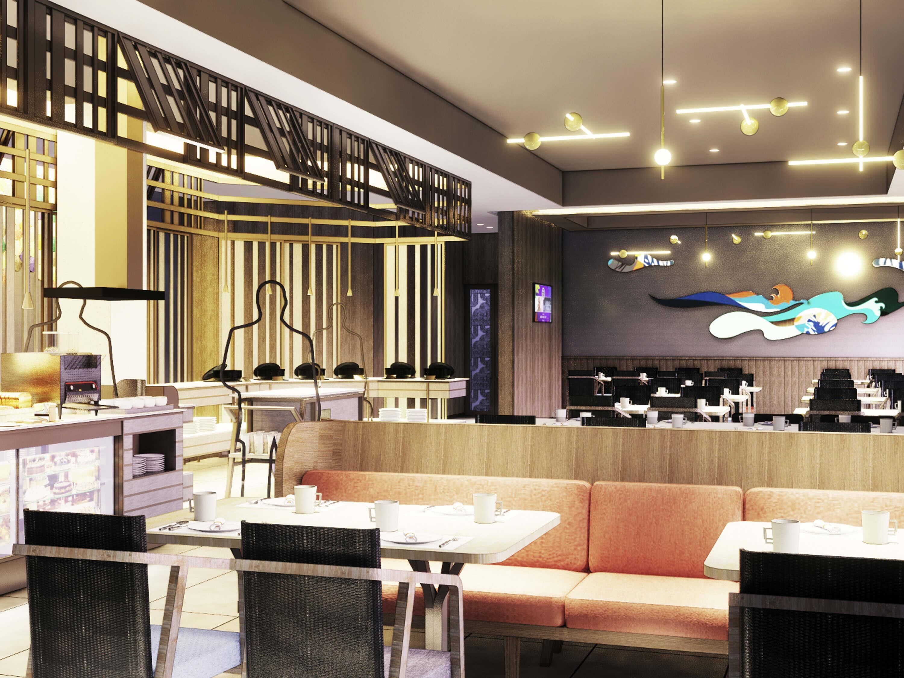 Un interior de restaurante moderno con una barra larga, cabinas y un mural grande en la pared.