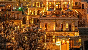 A historic building with multiple levels, stone architecture, and arched windows. - Capp Royal Cave Hotel (Ürgüp)