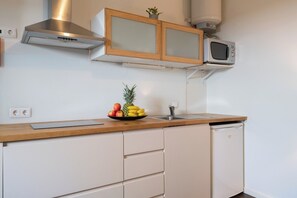 Enjoy cooking in this well-equipped kitchen with a range, microwave, and sink.