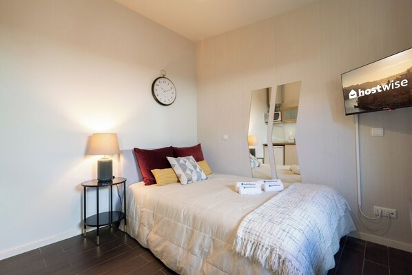 Relax in a stylish room with a comfortable bed, flat-screen TV, and kitchenette.