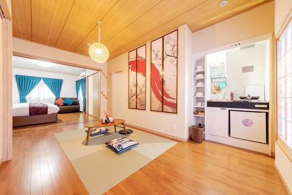 Cozy living space with a comfortable seating area, kitchenette, and artwork.