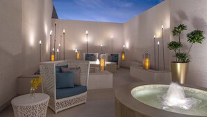 A modern outdoor lounge area with seating, a hot tub, and ambient lighting. - Steigenberger Residence Doha (Doha)