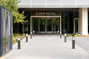 The entrance to the Zleep Hotel with a modern design, featuring a glass facade and a clear sign above the doors. - Zleep Hotel Madrid Airport (Madrid)