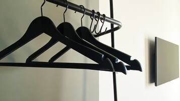A wall-mounted coat rack with several hangers.
