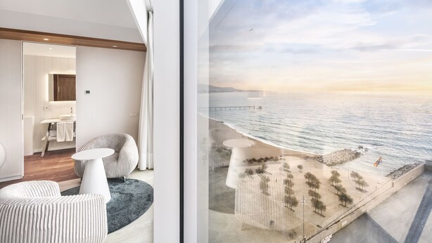 A modern interior with a view of a coastal promenade. - Hotel Marina Badalona (Badalona)