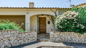 A stone-walled entrance with a wooden door, a stone staircase, and a number '13' sign. - Villa "Castell Mirto" with Private Pool, Terraces & Wi-Fi (Calonge)