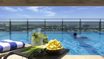 Outdoor pool, open 8:00 AM to 6:00 PM, pool loungers, lifeguards on site