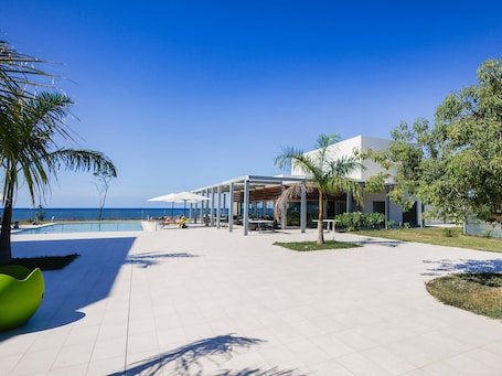 Outdoor pool, pool umbrellas, pool loungers. Ibis Styles Mayotte Aeroport