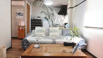 Relax in this inviting bedroom with a large bed, coffee table, and comfortable workspace.