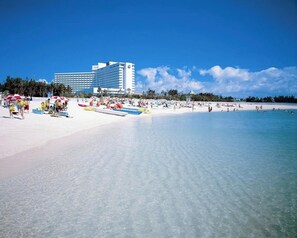 Guests can enjoy the beach with umbrellas and lounge chairs.