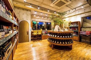 Cozy space with a wine display, shelves, and a round table for dining.