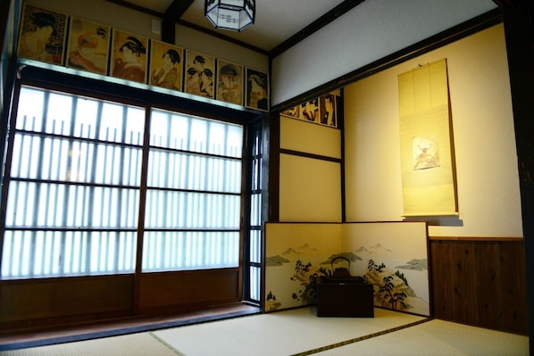 Experience the serene ambiance of a traditional Japanese room with tatami flooring and shoji screens.