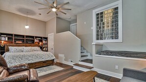 A bedroom with a bed, a desk, a chair, a ceiling fan, and a window with a view. - Asheville Rustic Cabin: Hot Tub, Pets ok, Fire Pit (Asheville)