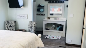 A bedroom with a bed, a TV, a vanity, and a mirror. - Lily’s Pad 5 minute drive from the Interlochen Arts accademy (Interlochen)