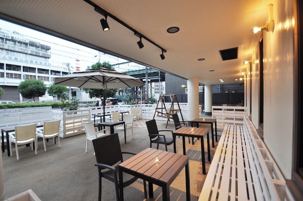 Enjoy a meal with a view from our outdoor seating area, offering views of the street and surrounding buildings.