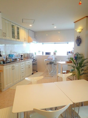 Enjoy meals in the well-lit kitchen with a central island and dining area.