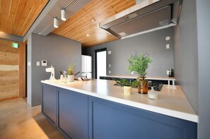 Enjoy cooking in this well-equipped kitchen with a large island and sink.