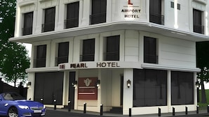 A multi-story building with a sign reading "The Pearl Airport Hotel." - The Pearl Airport Hotel (Arnavutköy)