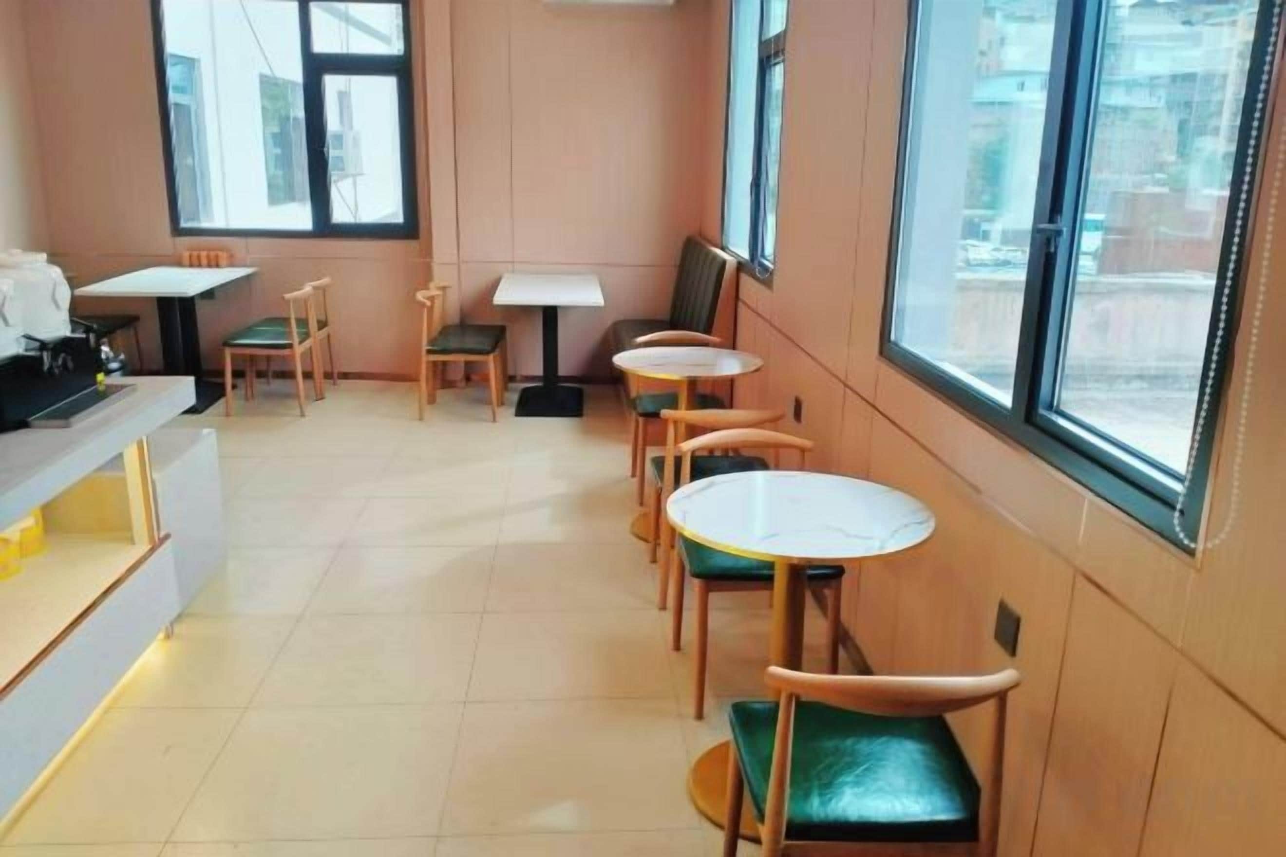 A cafe with tables and chairs arranged for seating.