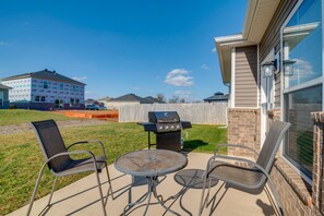 A patio with a grill, two chairs, and a table. - Lovely Bowling Green Home, 10 Mi to Downtown! (Bowling Green)