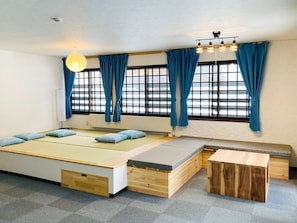 A modern room with a large bed, a bench, and a small table.