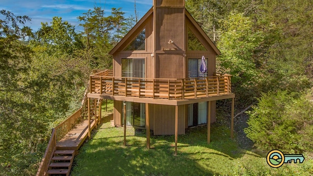 A wooden cabin with a balcony, surrounded by trees. - Mountainside Chalet (#141A) - Close to Resort lodge | Great view of valley & golf course! (Basye)