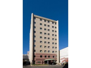 Stylish building with a central entrance and evenly spaced windows.
