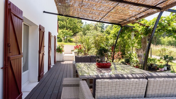 An outdoor patio with wicker furniture, a table, and a pergola. - Dorlanne - One Bedroom House, Sleeps 2 (Saint-Palais)