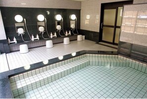 Enjoy a refreshing dip in the large pool surrounded by a stylish, grid-patterned floor and sleek, contemporary design.