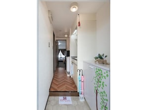Enter a serene space with a herringbone floor leading to a cozy room.