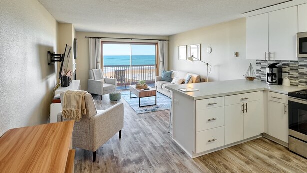 A modern apartment with a balcony, a kitchen, and a living area. - Ocean View Condo - Second Floor - Pet Friendly! (Lincoln City)