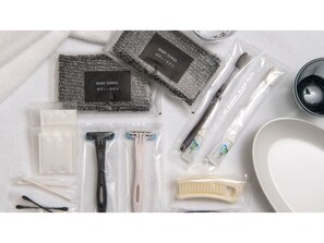 Guests can enjoy a selection of personal care items, including a towel, razor, shaving cream, and hairbrush.