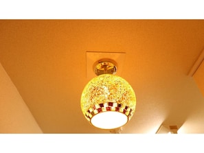 A ceiling with a textured, mosaic-patterned light fixture.