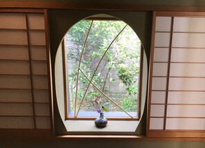 A window with a view of greenery outside.