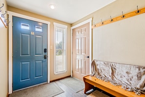 Enter through the blue door, flanked by two additional entrances, into a welcoming space.