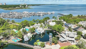 A marina with boats, a dock, and a small bridge.