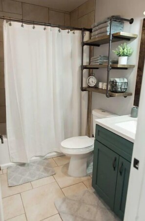 Combined shower/tub, hair dryer, towels, soap