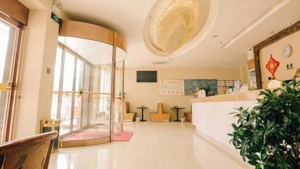 A hotel lobby with a curved reception desk, a glass partition, and a large circular ceiling feature. - Super 8 Hotel (Shucheng Chunqiu South Road Cimugong) (Shucheng)