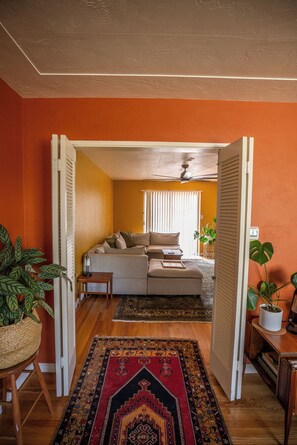 A cozy living room with a sofa, a coffee table, and a patterned rug. - Cozy Home with Downtown View -- 10 min drive to downtown! (San Diego)