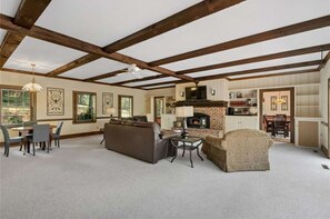 Cozy living area with a fireplace, dining table, and comfortable seating.