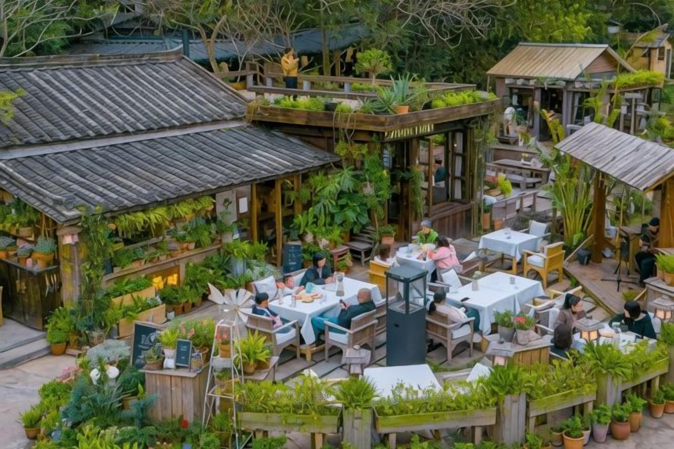 An outdoor restaurant with wooden tables and chairs, surrounded by lush greenery and potted plants.