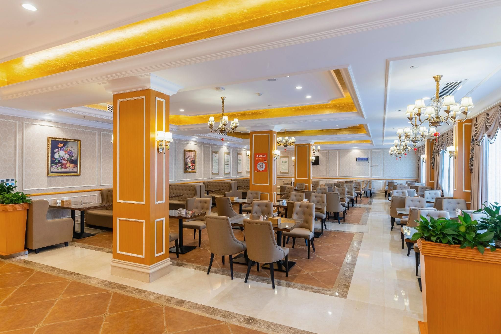 A spacious hotel lobby with multiple seating areas, including a bar and a dining section.