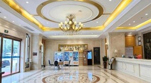 A hotel lobby with a reception desk, a chandelier, and a patterned floor. - Vienna Hotel (Luofu Mountain Scenic Area High-Speed Rail Station Branch) (Boluo)