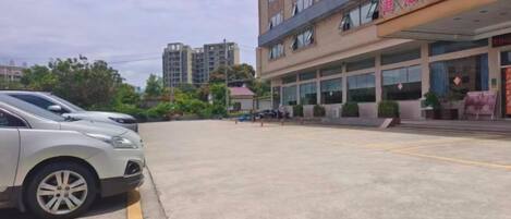 A parking lot with a building in the background.
