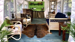 A tent with a kitchen area, seating, and a zebra rug. - Glamping on a Safari (Wendover)